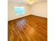 A primary bedroom features wood flooring, a ceiling fan, a double-door closet, and lots of natural light at 332 Southern Sugar Ave, Moncks Corner, SC 29461