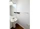 Well-lit powder room with pedestal sink and decorative shelving at 332 Southern Sugar Ave, Moncks Corner, SC 29461