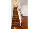 A beautiful staircase features hardwood steps, white risers and balusters, and a stained wood handrail at 332 Southern Sugar Ave, Moncks Corner, SC 29461