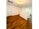 An upstairs landing with wood flooring and white trim, adjacent to bedrooms, attic access, and living space at 332 Southern Sugar Ave, Moncks Corner, SC 29461