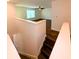 From the top of the stairs, view the spacious upstairs landing and living room with ceiling fan and large window at 332 Southern Sugar Ave, Moncks Corner, SC 29461