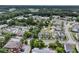 High angle aerial view of a community including residential houses, a pond, parking and commercial buildings at 3408 Salterbeck St, Mount Pleasant, SC 29466