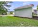 Backyard showcasing the side of the house with green lawn and mulch at 3408 Salterbeck St, Mount Pleasant, SC 29466