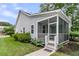 View of the side and screened in back porch showing the lawn and landscaping at 3408 Salterbeck St, Mount Pleasant, SC 29466