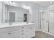 Bright bathroom features double sink vanity, neutral walls, and glass shower with a bench at 3408 Salterbeck St, Mount Pleasant, SC 29466