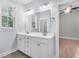 Neutral bathroom with double sink vanity, ample lighting, and a view into the main bedroom at 3408 Salterbeck St, Mount Pleasant, SC 29466