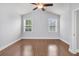 Bright bedroom with hardwood floors, ceiling fan, and two large windows at 3408 Salterbeck St, Mount Pleasant, SC 29466