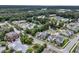 Extensive aerial view of a community showing the lake, clubhouse, and residential area amidst lush trees at 3408 Salterbeck St, Mount Pleasant, SC 29466