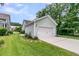 View of the garage of the home with green siding and a freshly mowed lawn at 3408 Salterbeck St, Mount Pleasant, SC 29466