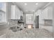 Spacious kitchen boasts stainless appliances, granite counters, and stylish cabinets at 3408 Salterbeck St, Mount Pleasant, SC 29466