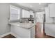 Bright kitchen features stainless appliances, granite counters, and hardwood floors at 3408 Salterbeck St, Mount Pleasant, SC 29466