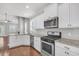 Well-equipped kitchen includes stainless appliances, granite counters, and hardwood floors at 3408 Salterbeck St, Mount Pleasant, SC 29466