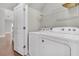 Laundry room with a modern washer and dryer, ample storage, and wood floors at 3408 Salterbeck St, Mount Pleasant, SC 29466