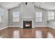 Spacious living room featuring wood floors, fireplace, and ample windows at 3408 Salterbeck St, Mount Pleasant, SC 29466