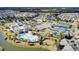 Aerial view of the community with a pool, tennis courts, and winding waterways surrounded by homes at 350 Dahlia Row Dr, Summerville, SC 29486