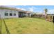 Spacious backyard with lush lawn, manicured landscaping, and a black fence providing privacy at 350 Dahlia Row Dr, Summerville, SC 29486