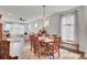 Open-concept dining area with wood table and seating for six in a naturally lit space at 350 Dahlia Row Dr, Summerville, SC 29486