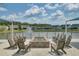 Inviting outdoor fire pit area overlooking a serene lake with a fountain, perfect for gathering and enjoying the community's beauty at 350 Dahlia Row Dr, Summerville, SC 29486