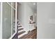 Bright foyer with elegant dark wood floors and a staircase, complemented by a stylish console table at 350 Dahlia Row Dr, Summerville, SC 29486