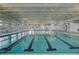 Spacious indoor pool with lap lanes and ample natural light, offering a year-round swimming and fitness option for residents at 350 Dahlia Row Dr, Summerville, SC 29486