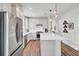Bright kitchen featuring white cabinets, stainless steel appliances, and a center island with pendant lights at 350 Dahlia Row Dr, Summerville, SC 29486