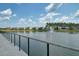 Scenic lake view featuring a charming fountain and a row of beautiful homes, creating a picturesque and tranquil community setting at 350 Dahlia Row Dr, Summerville, SC 29486
