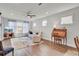 Bright living area featuring hardwood floors, ceiling fan, and comfortable seating at 350 Dahlia Row Dr, Summerville, SC 29486