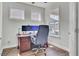 Bright home office featuring hardwood floors, three windows providing natural light, and a dark wooden desk at 350 Dahlia Row Dr, Summerville, SC 29486