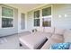 Covered patio area with comfortable outdoor seating and views of the home's exterior at 350 Dahlia Row Dr, Summerville, SC 29486
