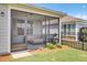 Inviting screened-in porch with outdoor furniture, plants, and access to the well-maintained backyard at 350 Dahlia Row Dr, Summerville, SC 29486