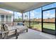 Relaxing screened-in porch featuring cushioned seating and views of the landscaped backyard with a black fence at 350 Dahlia Row Dr, Summerville, SC 29486