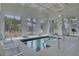 Indoor spa with chair lift, chairs, and large windows overlooking the landscaping at 350 Dahlia Row Dr, Summerville, SC 29486