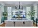 Stylish dining room features large windows, a modern chandelier, and seating for six at 3805 Adrian Way, Mount Pleasant, SC 29466