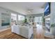 Open living room with white sofas, fireplace and access to the kitchen, creating an inviting living space at 3805 Adrian Way, Mount Pleasant, SC 29466