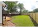 A spacious backyard featuring a lush lawn, a wooden deck, and secure wooden fencing at 397 Parkdale Dr, Charleston, SC 29414