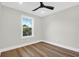 Bright bedroom with hardwood floors, a modern ceiling fan, and ample natural light from the large window at 397 Parkdale Dr, Charleston, SC 29414