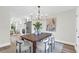 Bright dining room featuring a modern chandelier, wooden table, and a view of the adjacent kitchen at 397 Parkdale Dr, Charleston, SC 29414