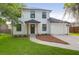 Beautifully renovated two-story home featuring a manicured lawn and a private driveway leading to an attached garage at 397 Parkdale Dr, Charleston, SC 29414