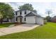 Charming two-story home with a well-maintained lawn and long driveway to the attached garage provides ample parking at 397 Parkdale Dr, Charleston, SC 29414