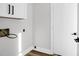 Utility room featuring overhead cabinets and a door to another part of the house at 397 Parkdale Dr, Charleston, SC 29414