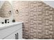 Stylish powder room showcasing designer wallpaper, a modern round mirror, and a sleek vanity at 397 Parkdale Dr, Charleston, SC 29414