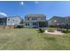 Spacious backyard featuring a fire pit, screened-in patio, and green lawn at 415 W Respite Ln, Summerville, SC 29483