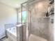 Well-lit bathroom featuring a tub with shower, tiled walls, and contemporary fixtures at 415 W Respite Ln, Summerville, SC 29483