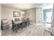 A dining room features a wooden table with gray chairs, wood floors, and a neutral color palette at 415 W Respite Ln, Summerville, SC 29483