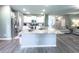 Open kitchen featuring white cabinetry, granite countertops, and modern appliances, adjacent to living space at 415 W Respite Ln, Summerville, SC 29483
