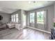 Bright living room with large windows, a comfortable sofa, and stylish decor, perfect for relaxing at 415 W Respite Ln, Summerville, SC 29483