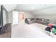 Spacious living room featuring a large sectional sofa, neutral carpet, and access to another room at 415 W Respite Ln, Summerville, SC 29483