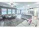 Spacious living room open to the kitchen, featuring plush sofas and abundant natural light at 415 W Respite Ln, Summerville, SC 29483