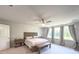 Sun-filled main bedroom with a large window, neutral decor, and a comfortable king-size bed at 415 W Respite Ln, Summerville, SC 29483