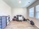 A simple office with a desk, chair, computer, drawers, and storage bins, as well as light wood floors at 415 W Respite Ln, Summerville, SC 29483